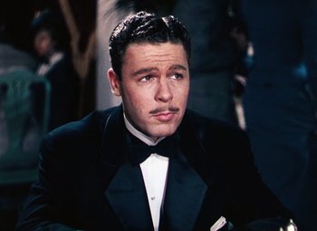 Movie still from “Hello Frisco, Hello” (1943), directed by H. Bruce Humberstone – A man in a tuxedo sitting in front of a mirror; Close Up shot, High angle