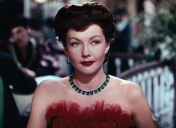 Movie still from “Hello Frisco, Hello” (1943), directed by H. Bruce Humberstone – A woman in a red dress and a green necklace; Close Up shot, Over the shoulder angle