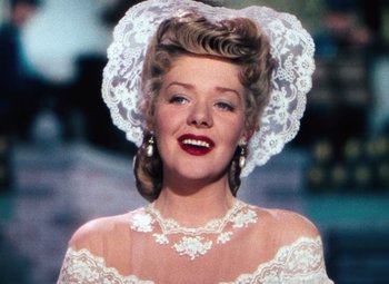 Movie still from “Hello Frisco, Hello” (1943), directed by H. Bruce Humberstone – A person wearing a dress and a veil; Close Up shot, Low angle