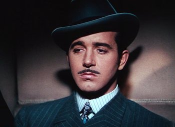 Movie still from “Hello Frisco, Hello” (1943), directed by H. Bruce Humberstone – A person wearing a suit and a hat; Close Up shot, Low angle