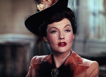 Movie still from “Hello Frisco, Hello” (1943), directed by H. Bruce Humberstone – A woman wearing a hat with a veil on top of her head; Close Up shot, Low angle