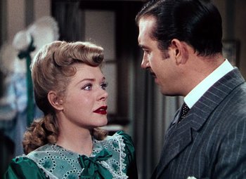 Movie still from “Hello Frisco, Hello” (1943), directed by H. Bruce Humberstone – A man and a woman are talking to each other; Close Up shot, Over the shoulder angle