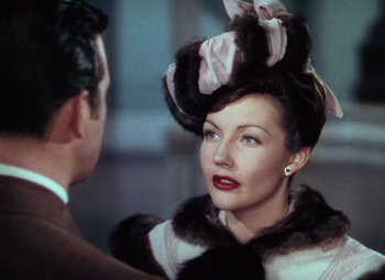 Movie still from “Hello Frisco, Hello” (1943), directed by H. Bruce Humberstone – A woman in a fur coat and a man in a suit and tie; Close Up shot, Over the shoulder angle