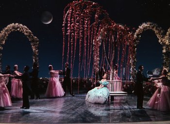 Movie still from “Hello Frisco, Hello” (1943), directed by H. Bruce Humberstone – A group of people standing around a stage; Extreme Wide shot, High angle