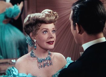 Movie still from “Hello Frisco, Hello” (1943), directed by H. Bruce Humberstone – A woman in a blue dress talking to a man in a black suit; Close Up shot, Over the shoulder angle