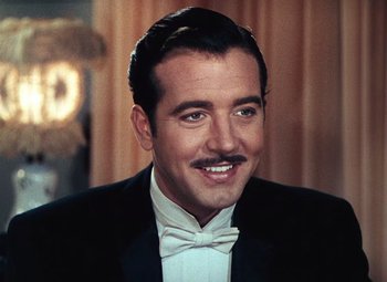 Movie still from “Hello Frisco, Hello” (1943), directed by H. Bruce Humberstone – A person wearing a suit and bow tie; Close Up shot, Low angle