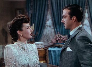 Movie still from “Hello Frisco, Hello” (1943), directed by H. Bruce Humberstone – A man and a woman standing next to each other in a room; Medium shot, Low angle