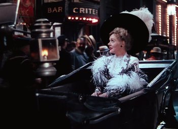 Movie still from “Hello Frisco, Hello” (1943), directed by H. Bruce Humberstone – A woman sitting in a chair with an open umbrella; Medium shot, Over the shoulder angle