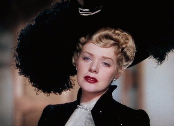 Movie still from “Hello Frisco, Hello” (1943), directed by H. Bruce Humberstone – An older woman wearing a black hat and a white dress; Close Up shot, Low angle