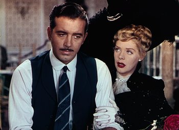 Movie still from “Hello Frisco, Hello” (1943), directed by H. Bruce Humberstone – A man and a woman standing next to each other; Medium shot, Low angle