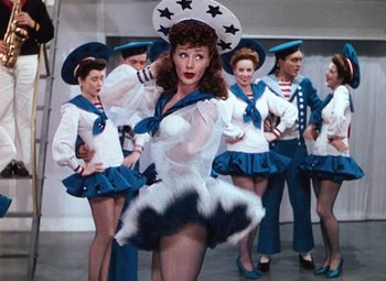 Movie still from “Hello Frisco, Hello” (1943), directed by H. Bruce Humberstone – A group of people dressed in sailor outfits; Medium shot, Low angle