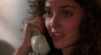 Movie still from “Hellraiser” (1987), directed by Clive Barker – A person talking on a phone; Close Up shot, Overhead angle