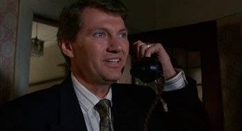 Movie still from “Hellraiser” (1987), directed by Clive Barker – A person talking on a phone; Close Up shot, Low angle