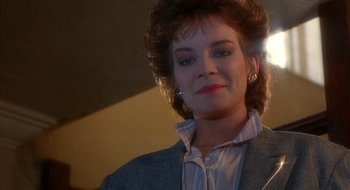 Movie still from “Hellraiser” (1987), directed by Clive Barker – A person wearing a suit and tie; Close Up shot, Low angle