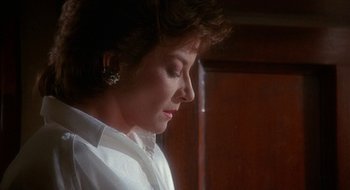 Movie still from “Hellraiser” (1987), directed by Clive Barker – A person wearing a white shirt; Close Up shot, Low angle