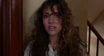 Movie still from “Hellraiser” (1987), directed by Clive Barker – A person with curly hair; Close Up shot, Over the shoulder angle