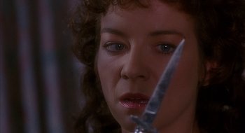 Movie still from “Hellraiser” (1987), directed by Clive Barker – A person holding a knife; Close Up shot, Over the shoulder angle