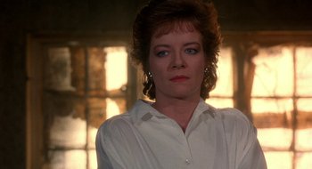 Movie still from “Hellraiser” (1987), directed by Clive Barker – A person wearing a white shirt; Close Up shot, Over the shoulder angle