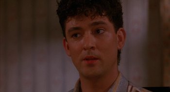 Movie still from “Hellraiser” (1987), directed by Clive Barker – A person wearing a shirt; Close Up shot, Over the shoulder angle