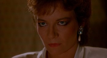 Movie still from “Hellraiser” (1987), directed by Clive Barker – A woman's face in a dark room; Close Up shot, Low angle