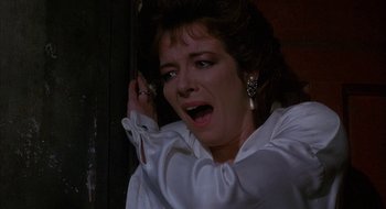 Movie still from “Hellraiser” (1987), directed by Clive Barker – A person wearing a white shirt; Close Up shot, Low angle