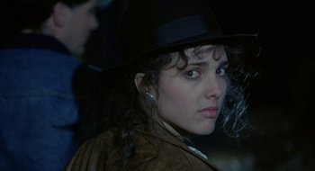 Movie still from “Hellraiser” (1987), directed by Clive Barker – A person wearing a hat; Close Up shot, Over the shoulder angle