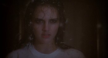 Movie still from “Hellraiser” (1987), directed by Clive Barker – A woman with wet hair is looking at the camera; Close Up shot, Over the shoulder angle