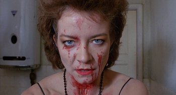 Movie still from “Hellraiser” (1987), directed by Clive Barker – A person with blood all over her face; Close Up shot, High angle