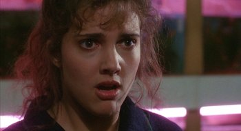 Movie still from “Hellraiser” (1987), directed by Clive Barker – A person with curly hair; Close Up shot, Over the shoulder angle