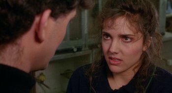 Movie still from “Hellraiser” (1987), directed by Clive Barker – A young woman looking at a man in a kitchen; Close Up shot, Over the shoulder angle