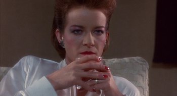 Movie still from “Hellraiser” (1987), directed by Clive Barker – A person holding a glass of wine; Close Up shot, Low angle