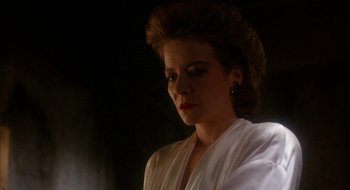 Movie still from “Hellraiser” (1987), directed by Clive Barker – A person wearing a white shirt; Close Up shot, Low angle