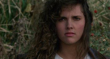 Movie still from “Hellraiser” (1987), directed by Clive Barker – A person with long curly hair; Close Up shot, Low angle