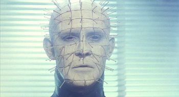 Movie still from “Hellraiser” (1987), directed by Clive Barker – The head of a man with a pinhead; Close Up shot, Low angle