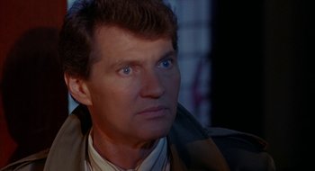 Movie still from “Hellraiser” (1987), directed by Clive Barker – A person wearing a jacket; Close Up shot, Over the shoulder angle