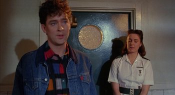Movie still from “Hellraiser” (1987), directed by Clive Barker – A man and a woman standing next to each other in a room; Medium shot, Over the shoulder angle