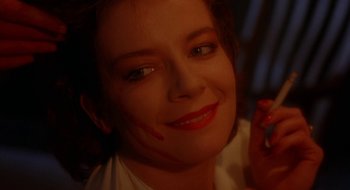 Movie still from “Hellraiser” (1987), directed by Clive Barker – A person with makeup on her face; Close Up shot, High angle