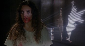 Movie still from “Hellraiser” (1987), directed by Clive Barker – A woman with blood all over her face; Close Up shot, Over the shoulder angle