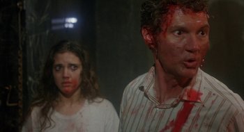 Movie still from “Hellraiser” (1987), directed by Clive Barker – A man and a woman are covered in blood; Close Up shot, Over the shoulder angle