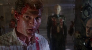 Movie still from “Hellraiser” (1987), directed by Clive Barker – A person with blood on his face; Close Up shot, Over the shoulder angle