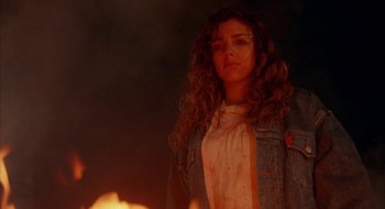 Movie still from “Hellraiser” (1987), directed by Clive Barker – A woman standing in front of a fire; Close Up shot, Low angle