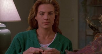 Movie still from “Hellraiser III: Hell on Earth” (1992), directed by Anthony Hickox – A woman holding a coffee cup in her hands; Close Up shot, Over the shoulder angle