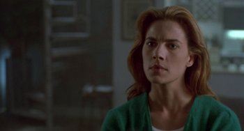 Movie still from “Hellraiser III: Hell on Earth” (1992), directed by Anthony Hickox – A person with long hair; Close Up shot, Over the shoulder angle