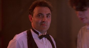 Movie still from “Hellraiser III: Hell on Earth” (1992), directed by Anthony Hickox – A person wearing a bow tie; Close Up shot, Low angle