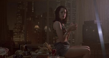 Movie still from “Hellraiser III: Hell on Earth” (1992), directed by Anthony Hickox – A woman sitting on the floor in a room; Medium shot, Over the shoulder angle