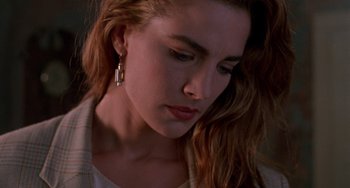 Movie still from “Hellraiser III: Hell on Earth” (1992), directed by Anthony Hickox – A person with long brown hair; Close Up shot, Over the shoulder angle