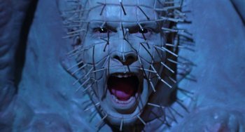 Movie still from “Hellraiser III: Hell on Earth” (1992), directed by Anthony Hickox – A man's face with spikes all over his head; Close Up shot, Low angle