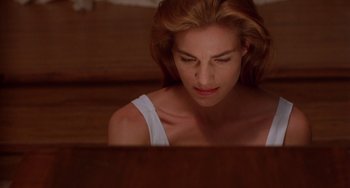 Movie still from “Hellraiser III: Hell on Earth” (1992), directed by Anthony Hickox – A woman sitting in front of a computer screen; Close Up shot, Low angle