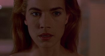 Movie still from “Hellraiser III: Hell on Earth” (1992), directed by Anthony Hickox – A woman's face in a dark room; Close Up shot, High angle