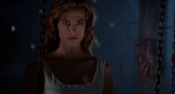 Movie still from “Hellraiser III: Hell on Earth” (1992), directed by Anthony Hickox – A beautiful woman standing in front of a blue wall; Close Up shot, Low angle